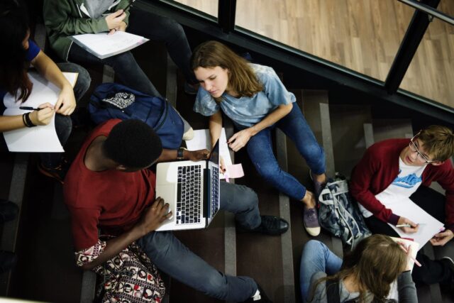 https://pathwaysedn.com/wp-content/uploads/2025/12/group-of-students-sitting-on-staircase-using-PRJVY2N-640x427.jpg